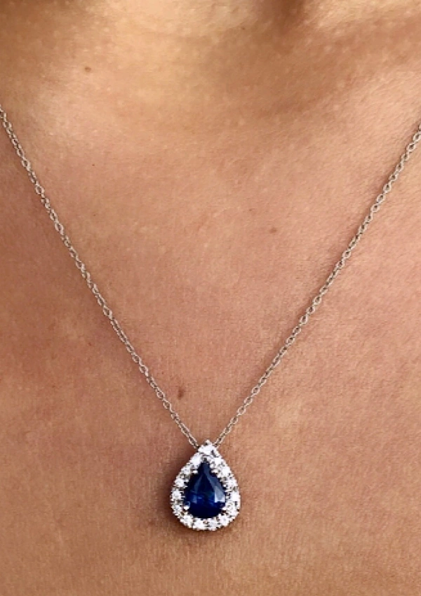 MORAIRA 18K white gold with a halo of brilliant cut diamonds crowned with a pear cut blue sapphire 2