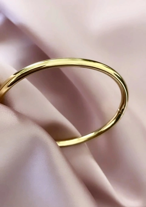 Pulseira rígida de secção REDONDA em ouro 18 quilates.