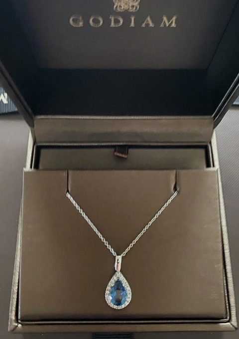 BLUE LAGOON 18K white gold diamond and LB topaz pendant.