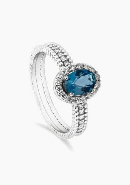 Anillo PATRICIA en oro blanco de 18 quilates con diamantes talla brillante coronado por un topacio London Blue talla oval